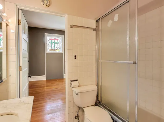 a bathroom with a toilet and a shower