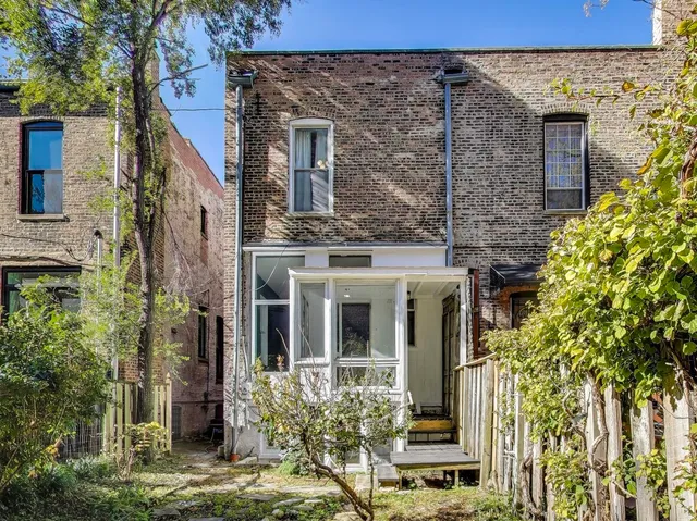 front view of a brick house with a large windows