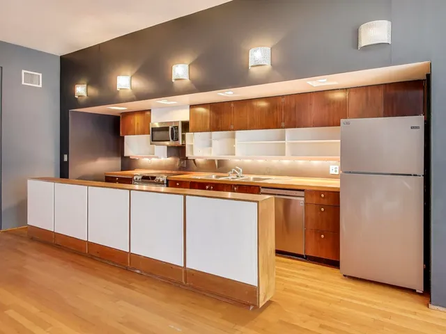 a kitchen with stainless steel appliances granite countertop a refrigerator and a sink