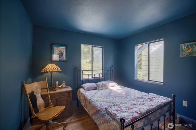 a bedroom with a bed and a large window