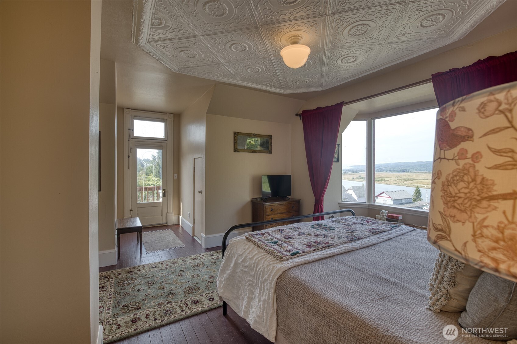 209 Ferry Street South Bend, WA 98586 - Photo 31 of 39 a bedroom with a bed and glass door