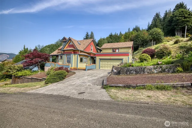 an aerial view of residential houses with outdoor space and parking
