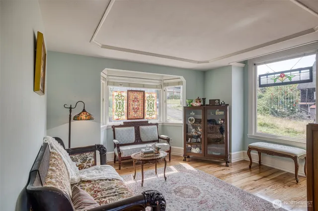 a room with furniture a rug and a window