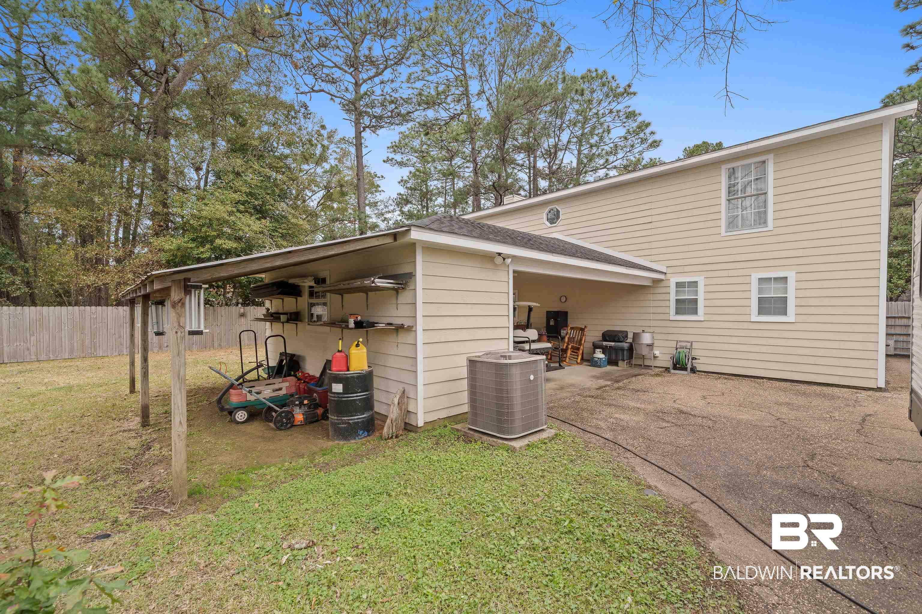 460 Ridgewood Drive Daphne, AL 36526 - Photo 30 of 31 Rear view of house featuring a yard and central AC unit