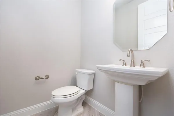 a bathroom with a sink a toilet and mirror