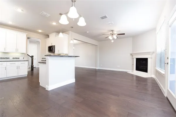 a view of a kitchen with a stove cabinets and wooden floor