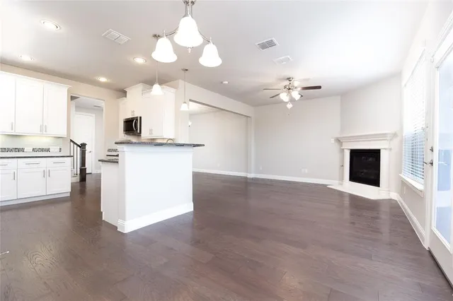 a view of a kitchen with a stove cabinets and wooden floor