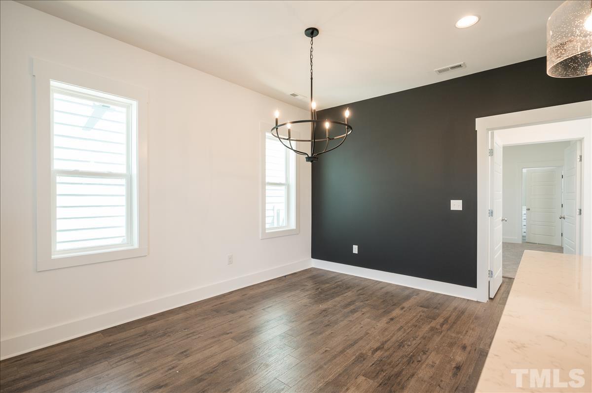 205 Daniel Ridge Road, Unit 1232 Wendell, NC 27591 - Photo 13 of 26 a view of a room with window chandelier and wooden floor