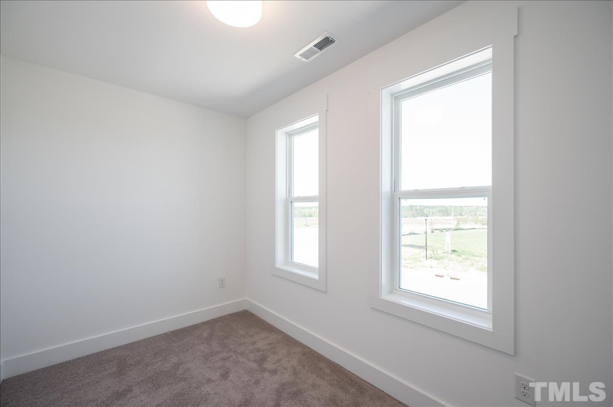 205 Daniel Ridge Road, Unit 1232 Wendell, NC 27591 - Photo 20 of 26 an empty room with a window