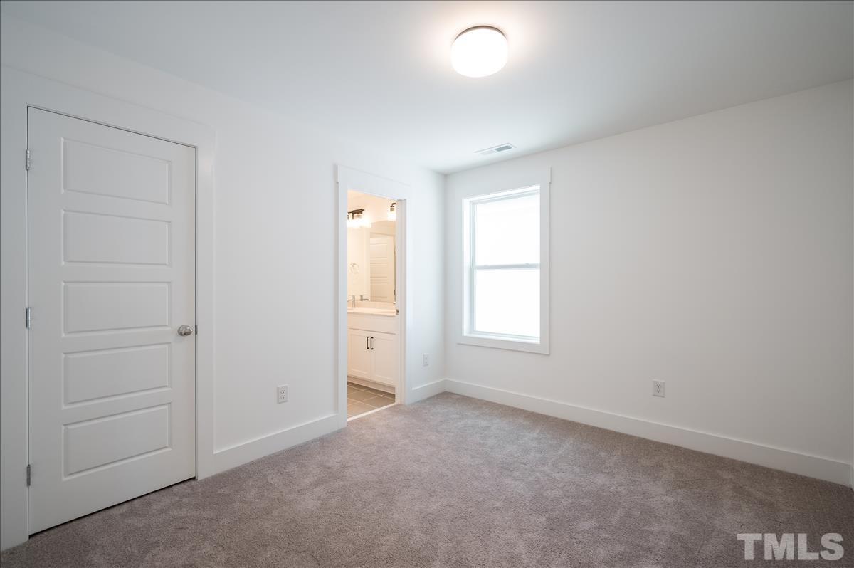 205 Daniel Ridge Road, Unit 1232 Wendell, NC 27591 - Photo 21 of 26 an empty room with windows