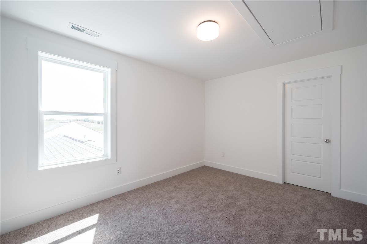 205 Daniel Ridge Road, Unit 1232 Wendell, NC 27591 - Photo 23 of 26 an empty room with a window