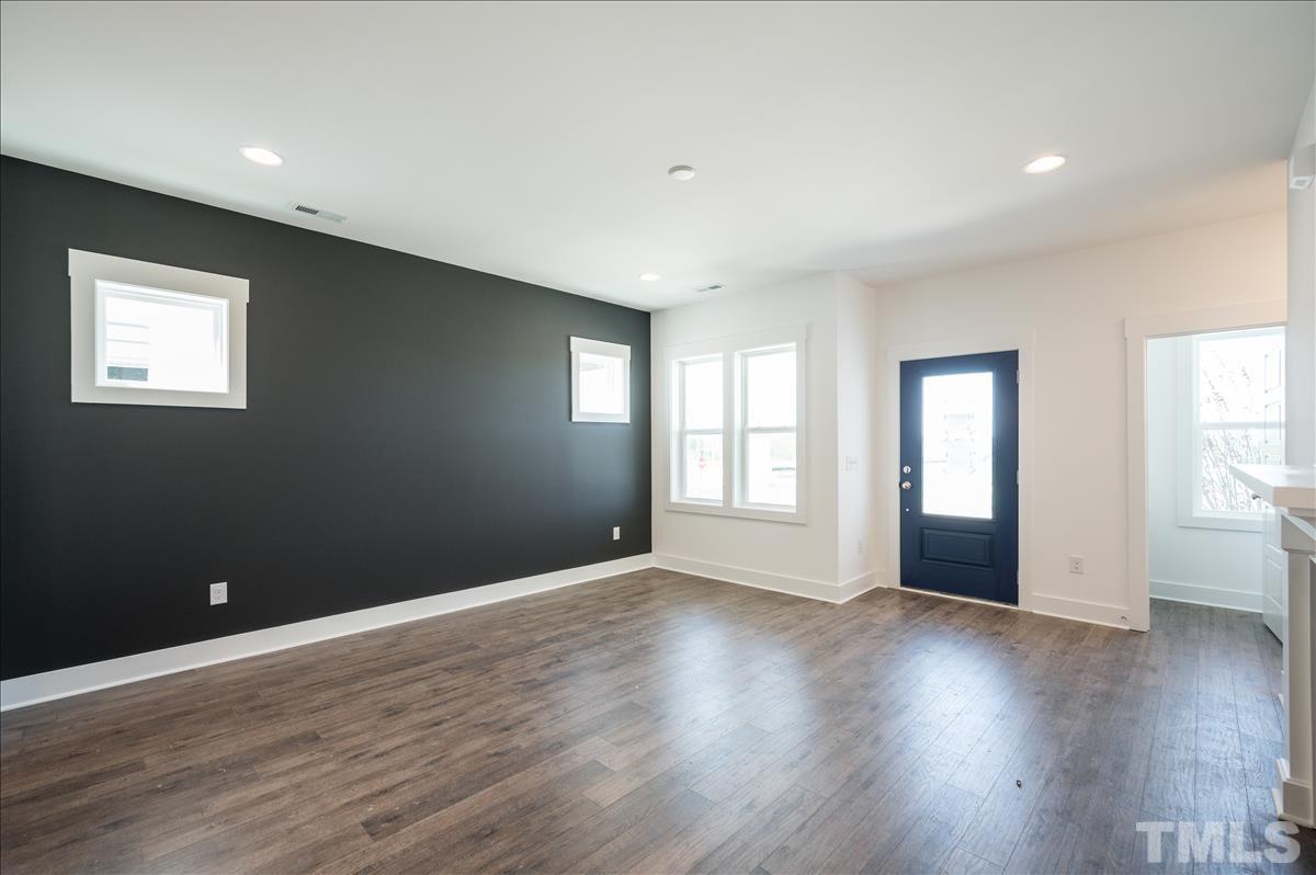 205 Daniel Ridge Road, Unit 1232 Wendell, NC 27591 - Photo 4 of 26 a view of an empty room with wooden floor and windows