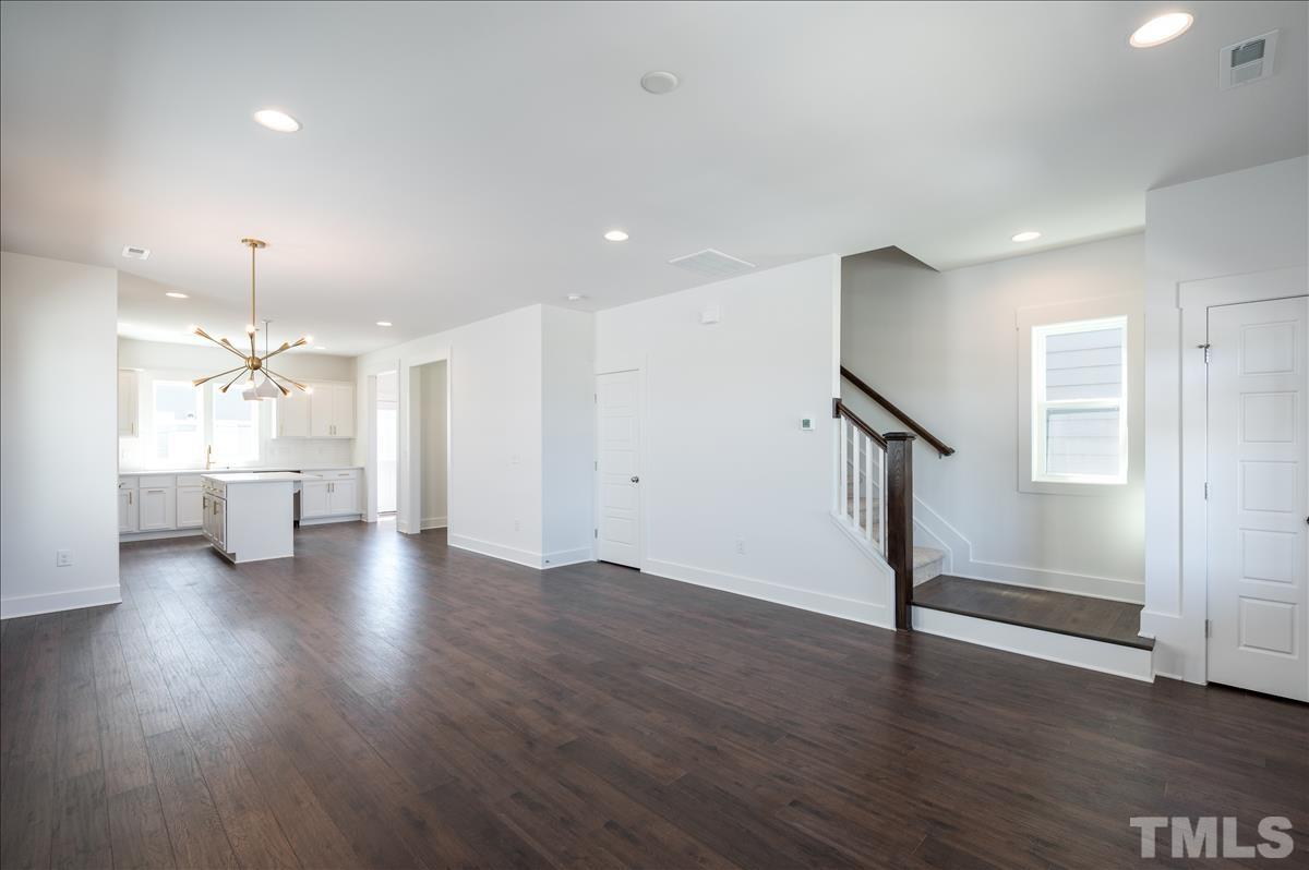 205 Daniel Ridge Road, Unit 1232 Wendell, NC 27591 - Photo 6 of 26 a view of a room with wooden floor staircase and a kitchen