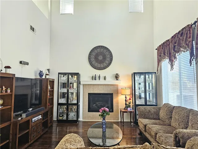 a living room with furniture a fireplace and a flat screen tv