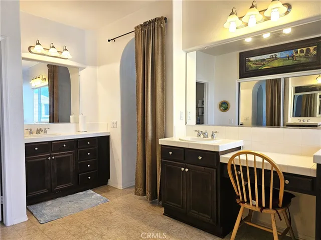 a bathroom with a sink vanity and a mirror