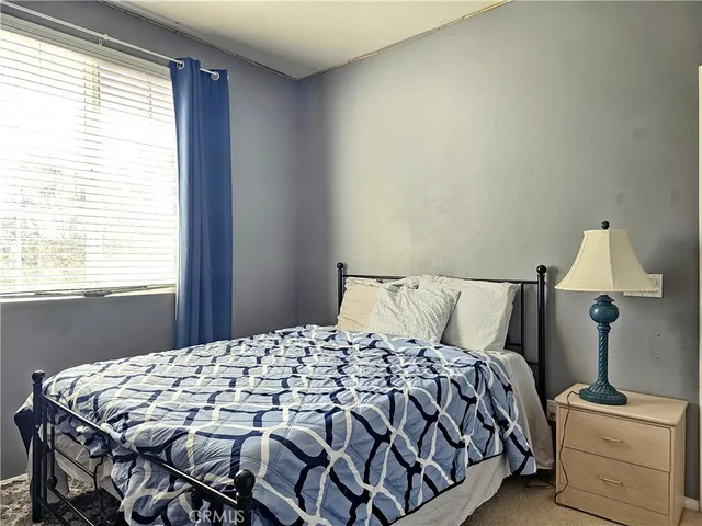 a bedroom with a bed and window