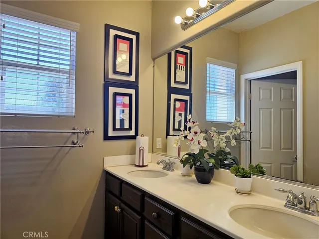 a bathroom with 2 sink and a mirror
