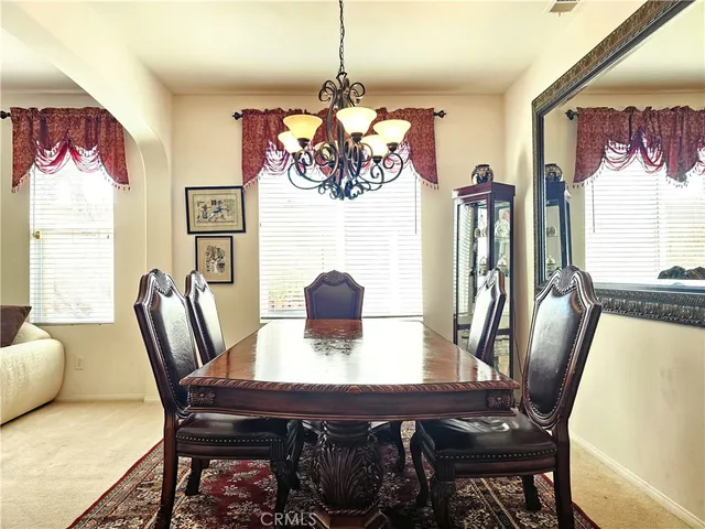 a view of a dining room with furniture window and outside view