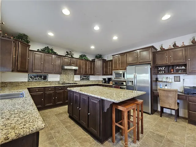 a large kitchen with cabinets table and chairs