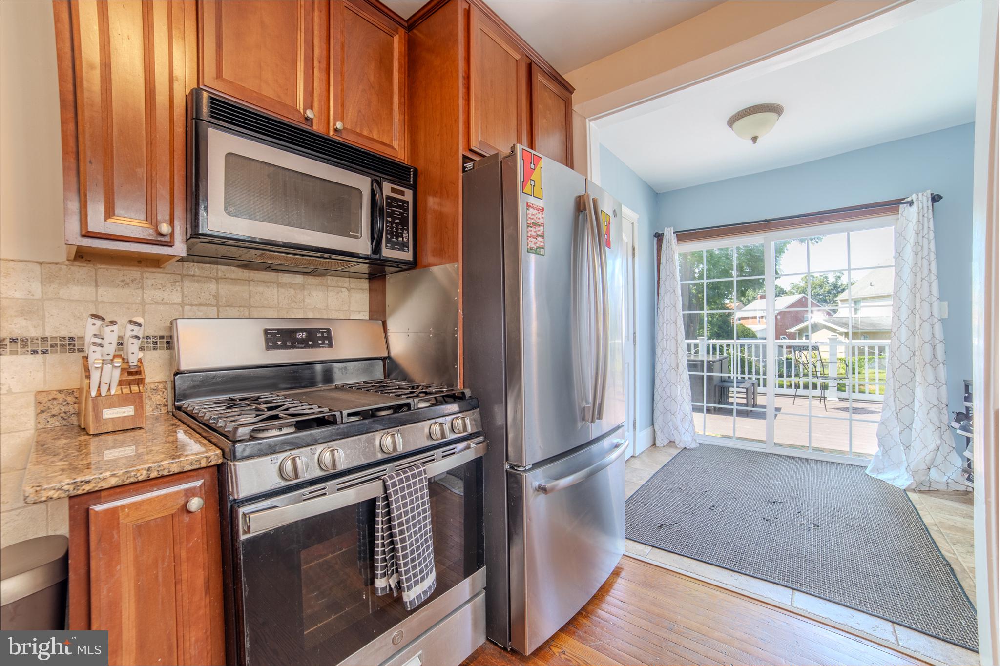 162 South Eagle Road Havertown, PA 19083 - Photo 11 of 30 a kitchen with granite countertop a stove and a microwave