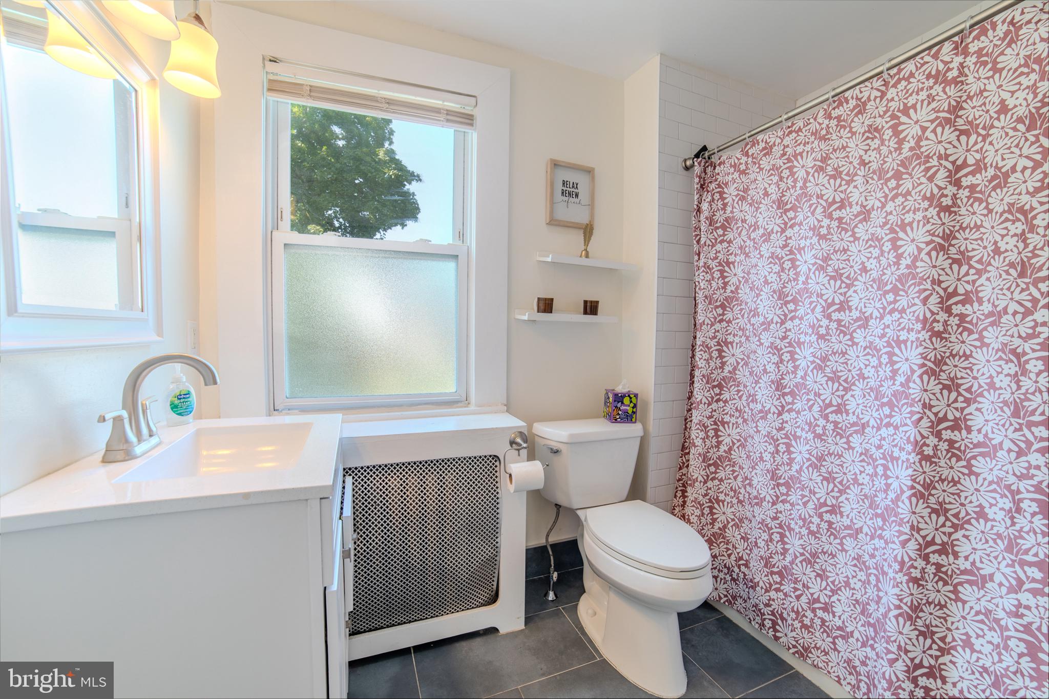 162 South Eagle Road Havertown, PA 19083 - Photo 16 of 30 a bathroom with a granite countertop toilet a sink a mirror and a shower