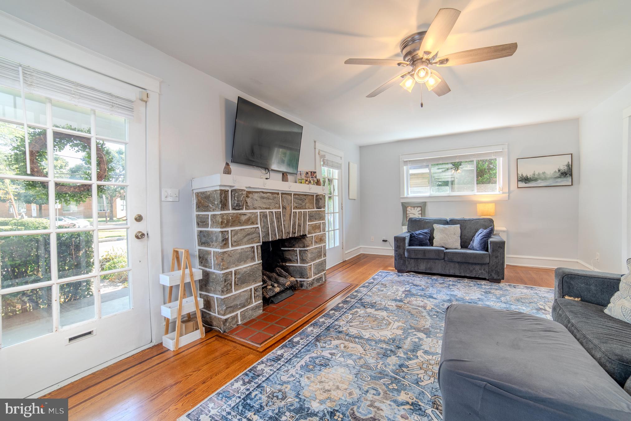 162 South Eagle Road Havertown, PA 19083 - Photo 6 of 30 a living room with furniture a flat screen tv and a fireplace