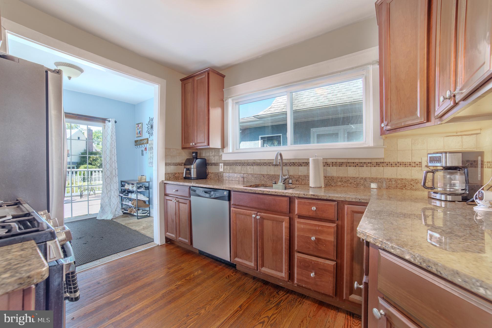 162 South Eagle Road Havertown, PA 19083 - Photo 10 of 30 a kitchen with stainless steel appliances granite countertop wooden cabinets a stove a sink and a large window