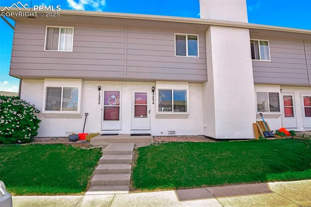 a front view of house and yard with green space
