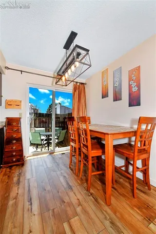 a dining room with furniture and wooden floor