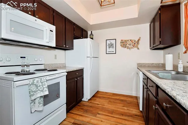 a kitchen with stainless steel appliances granite countertop a sink stove and microwave