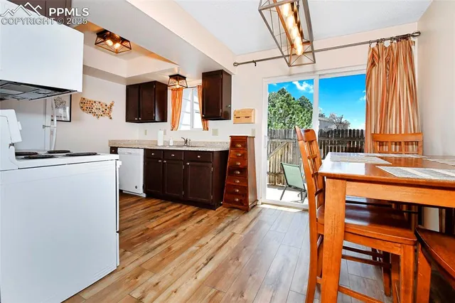 a kitchen with stainless steel appliances granite countertop a sink and wooden floors