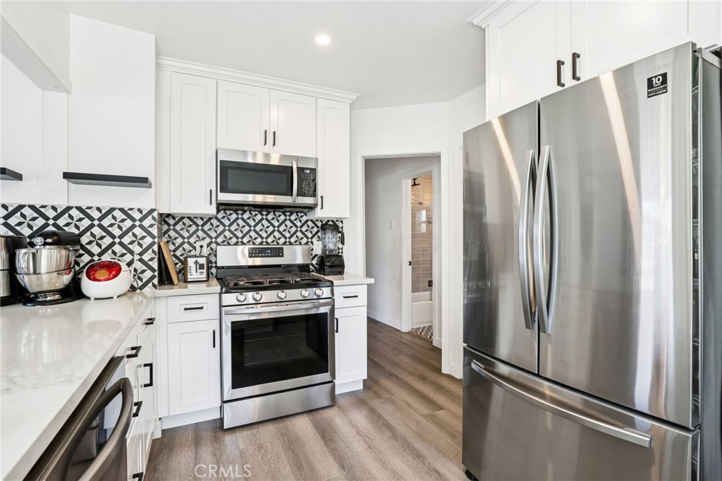 1448 Lemon Avenue Long Beach, CA 90813 - Photo 7 of 16 a kitchen with stainless steel appliances a stove a refrigerator and a sink