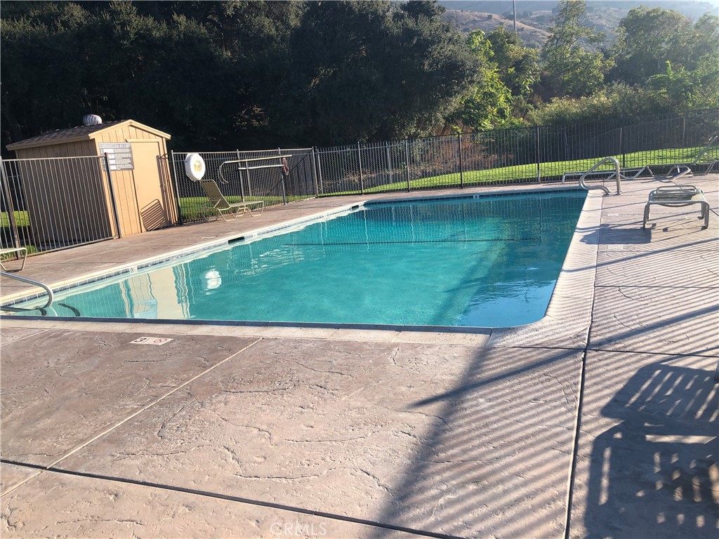 4901 Green River Road, Unit 113 Corona, CA 92878 - Photo 20 of 22 a view of a swimming pool with a patio