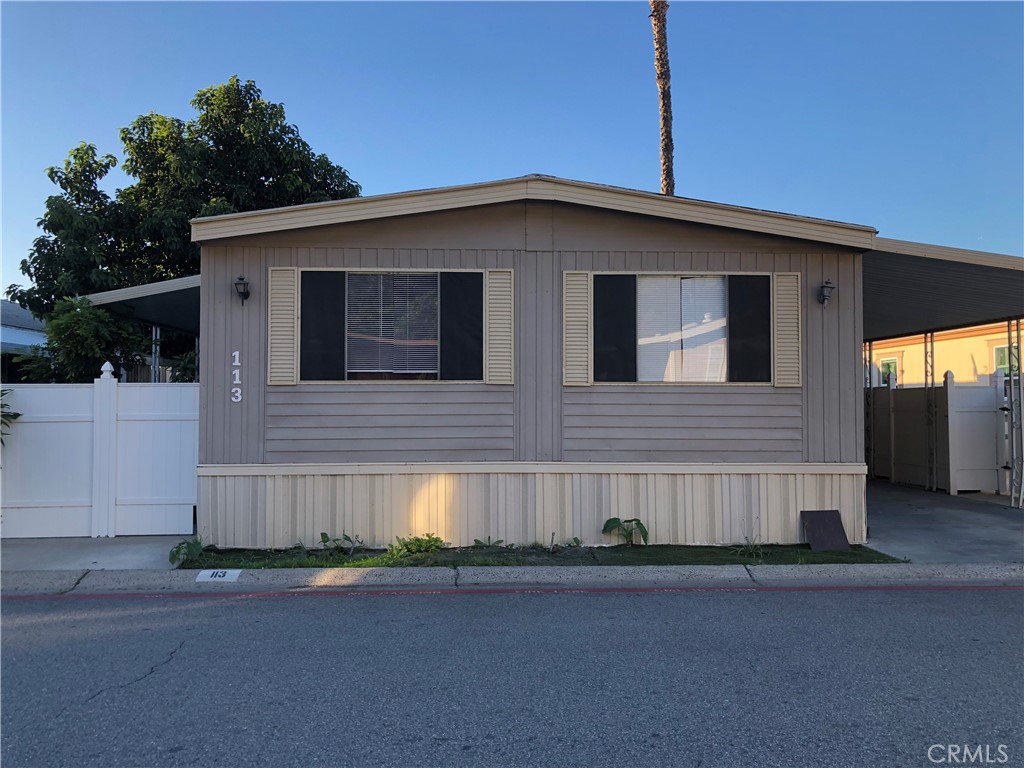 4901 Green River Road, Unit 113 Corona, CA 92878 - Photo 2 of 22 a front view of a house with garage