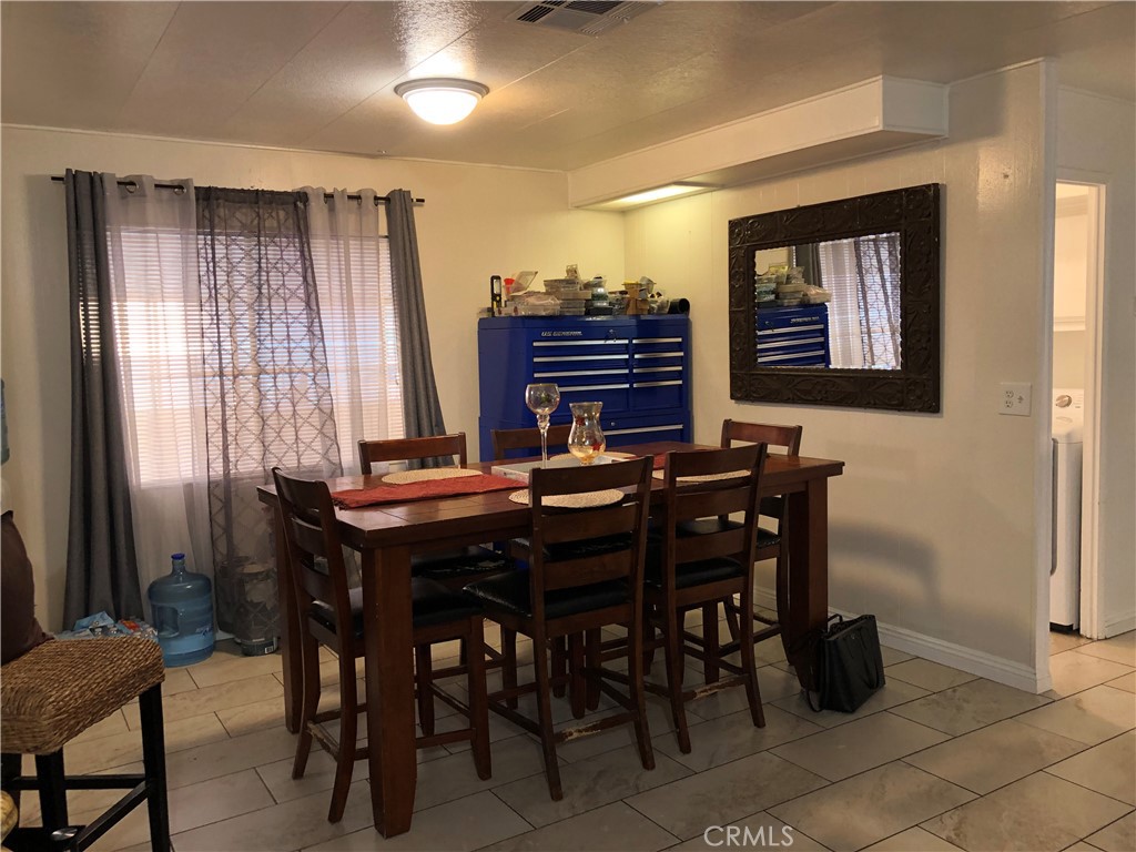 4901 Green River Road, Unit 113 Corona, CA 92878 - Photo 7 of 22 a view of a dining room with furniture and chandelier