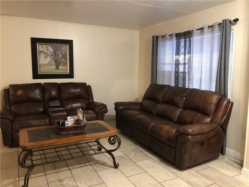 4901 Green River Road, Unit 113 Corona, CA 92878 - Photo 9 of 22 a living room with furniture and a window