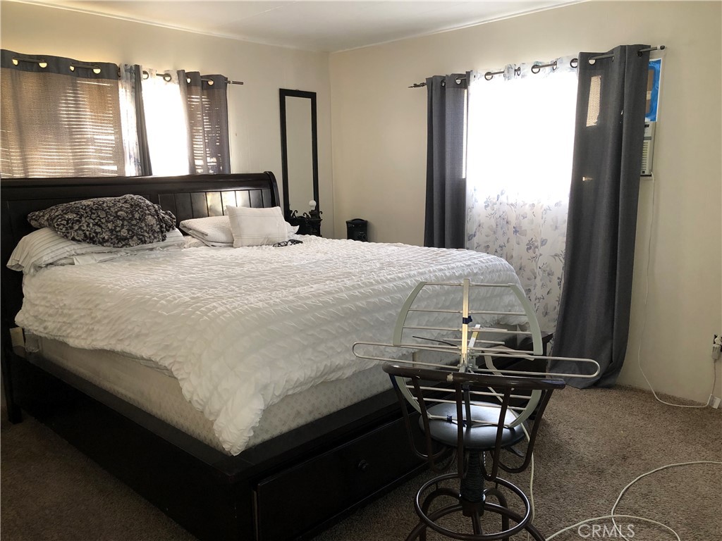 4901 Green River Road, Unit 113 Corona, CA 92878 - Photo 10 of 22 a bedroom with a bed and a window