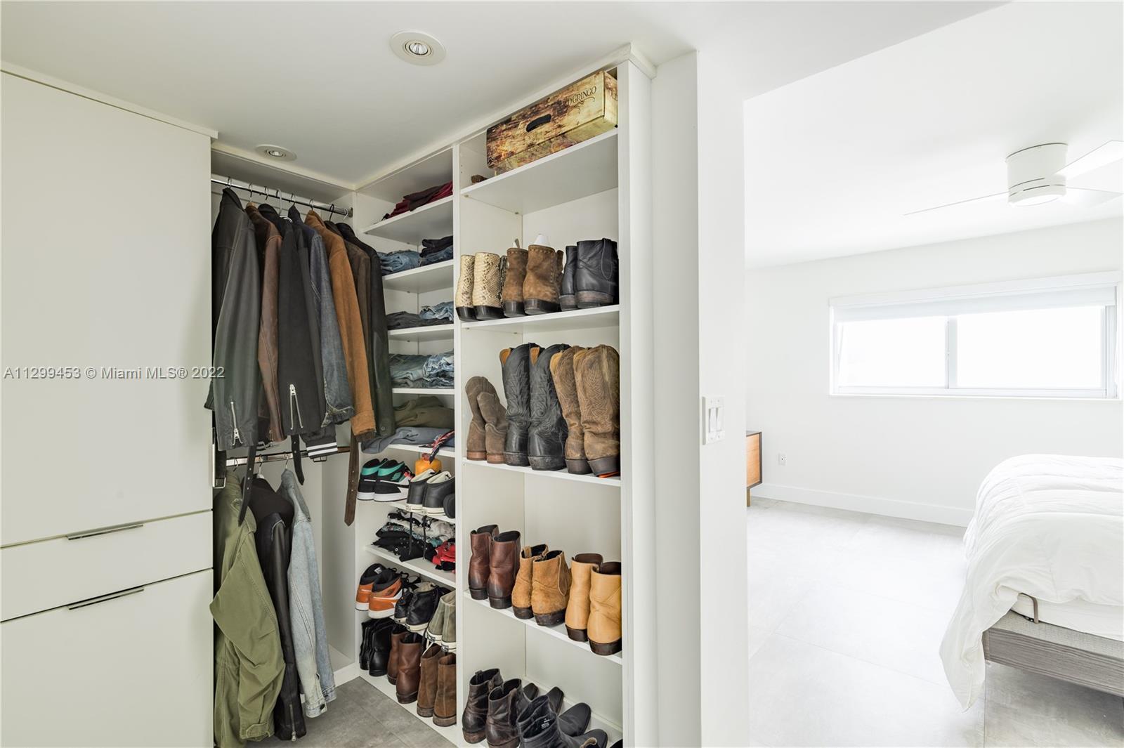1674 Bay Road, Unit 504 Miami Beach, FL 33139 - Photo 8 of 10 a view of walk in closet with clothes and shoes