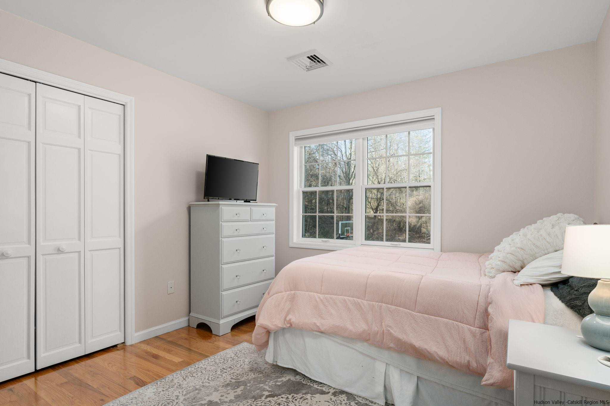 108 Ratterman Road Woodstock, NY 12498 - Photo 20 of 29 a bedroom with a bed and a flat tv screen on the dresser