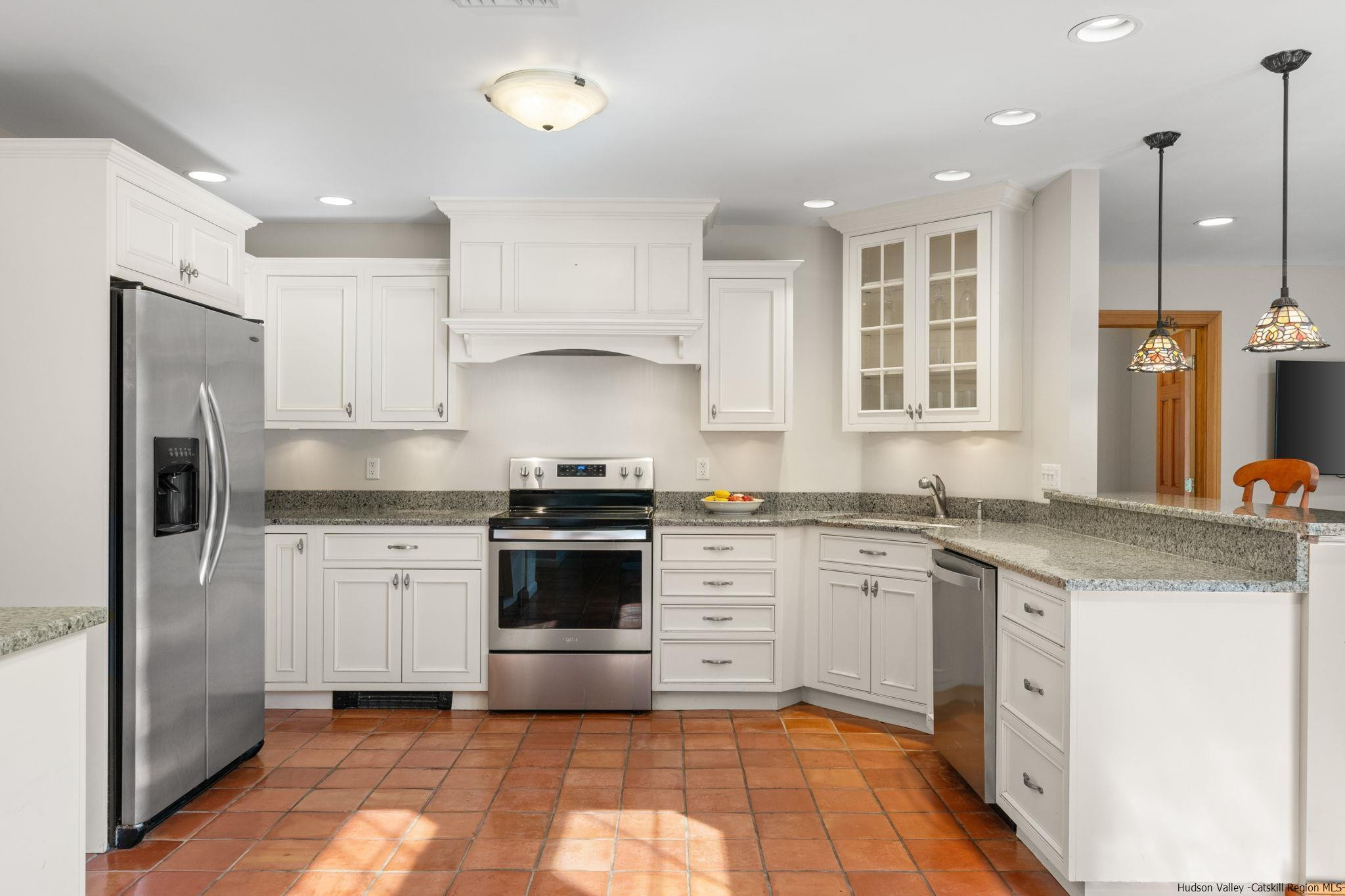 108 Ratterman Road Woodstock, NY 12498 - Photo 6 of 29 a kitchen with granite countertop a sink stove refrigerator and cabinets