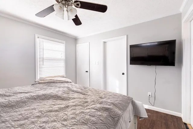 a bedroom with a bed and a flat screen tv
