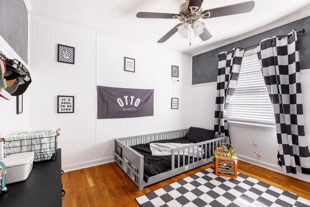 a very nice looking room with wooden floor and stairs