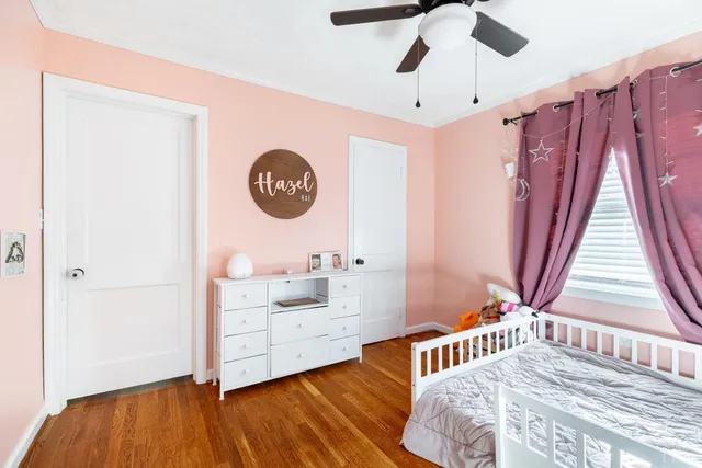 a bedroom with a large bed and a window