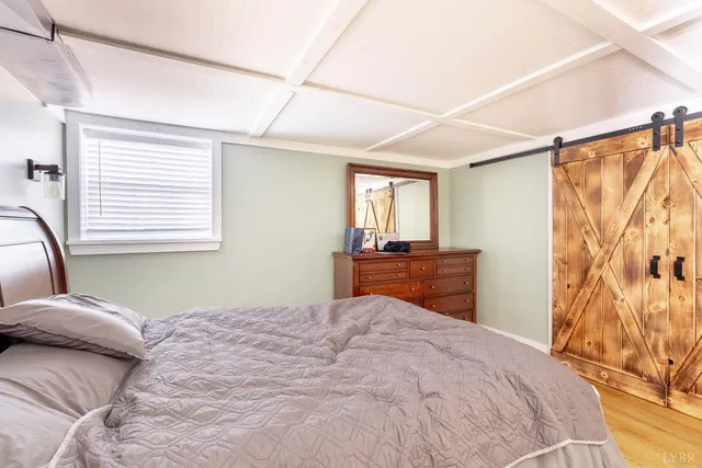 a living room with a flat screen tv and a walk in closet