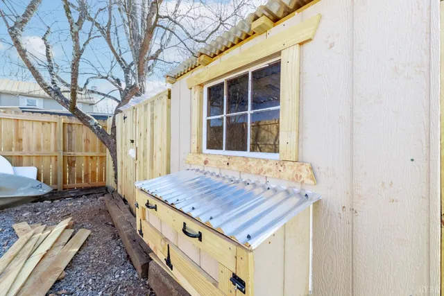 a view of a storage house utility room with a wooden door