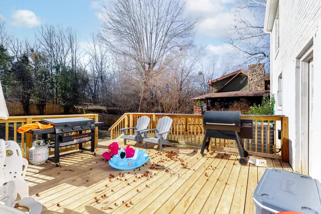 a yellow house sitting in middle of snow in front of house