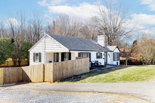 a aerial view of a house with a yard and sitting area