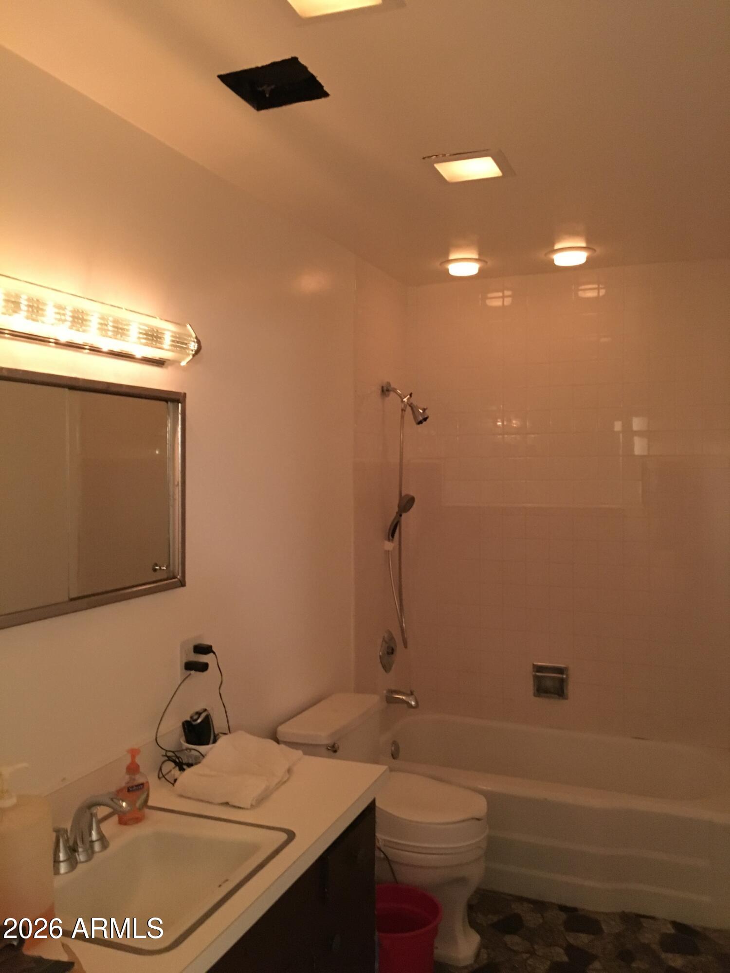 323 East Rose Lane Phoenix, AZ 85012 - Photo 20 of 20 a bathroom with a sink toilet and shower
