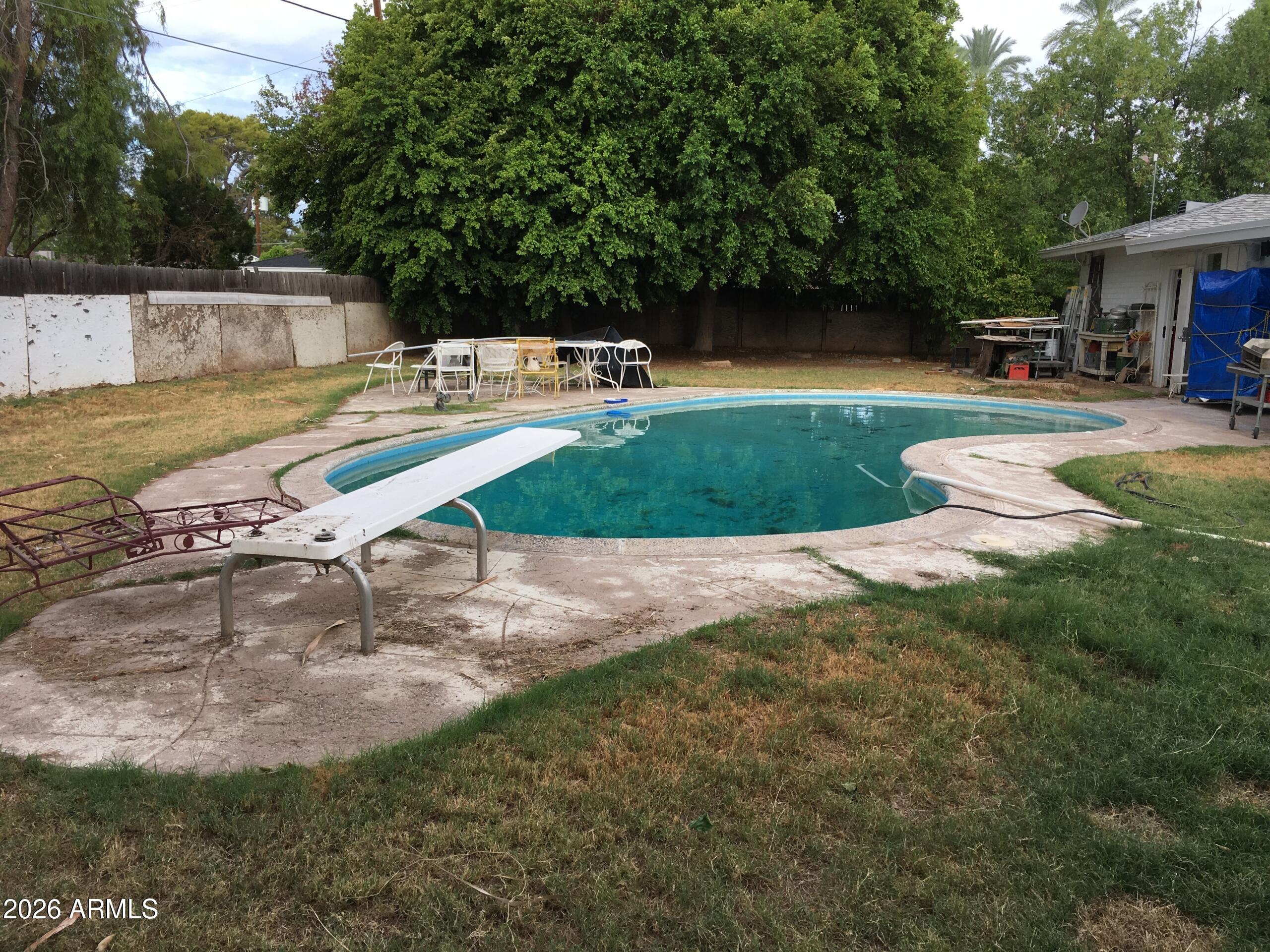 323 East Rose Lane Phoenix, AZ 85012 - Photo 8 of 20 a view of a swimming pool with a patio