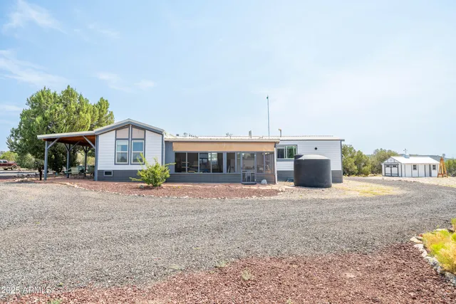 a view of a house with a yard and garage